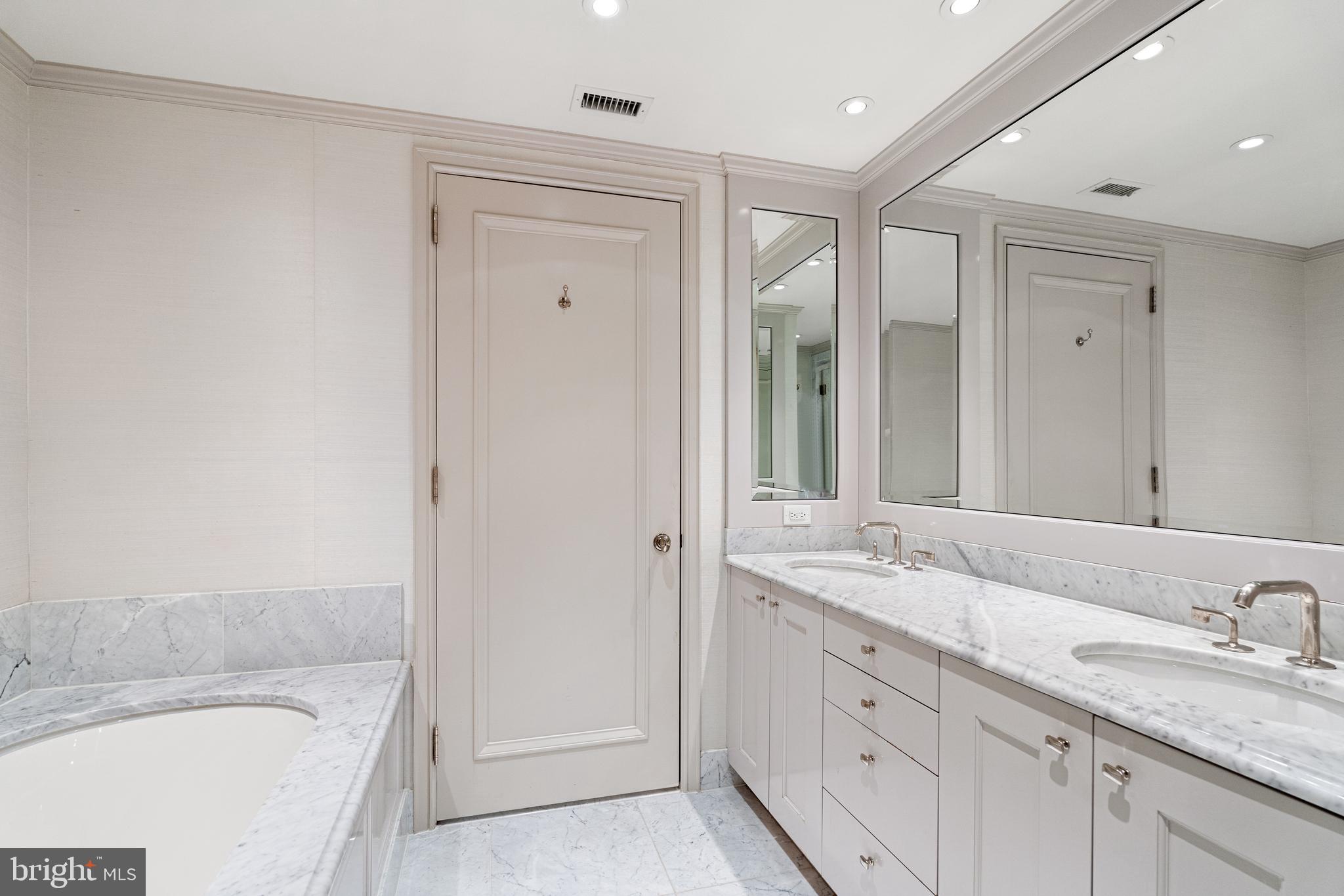 1111 23rd Street Northwest, Unit 4C Washington, DC 20037 - Photo 34 of 45 a bathroom with a granite countertop tub sink and mirror