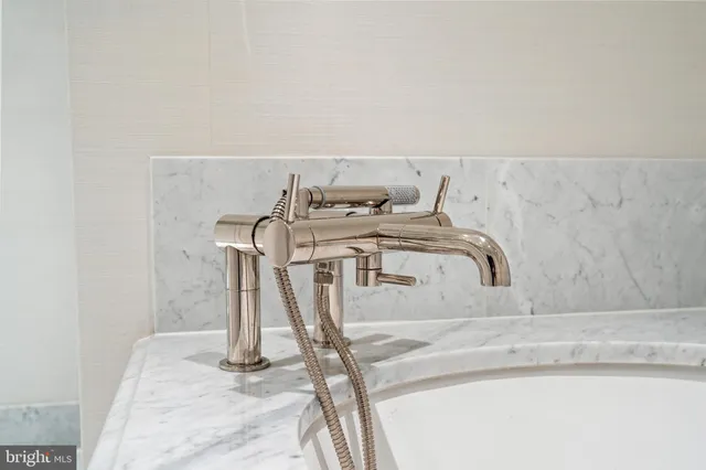 a bedroom with a bed and large windows