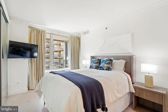 a bedroom with a bed and a mirror