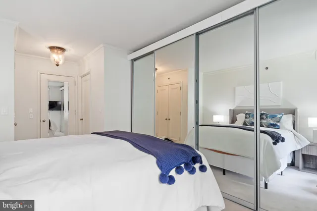 a bedroom with a bed and a lamp