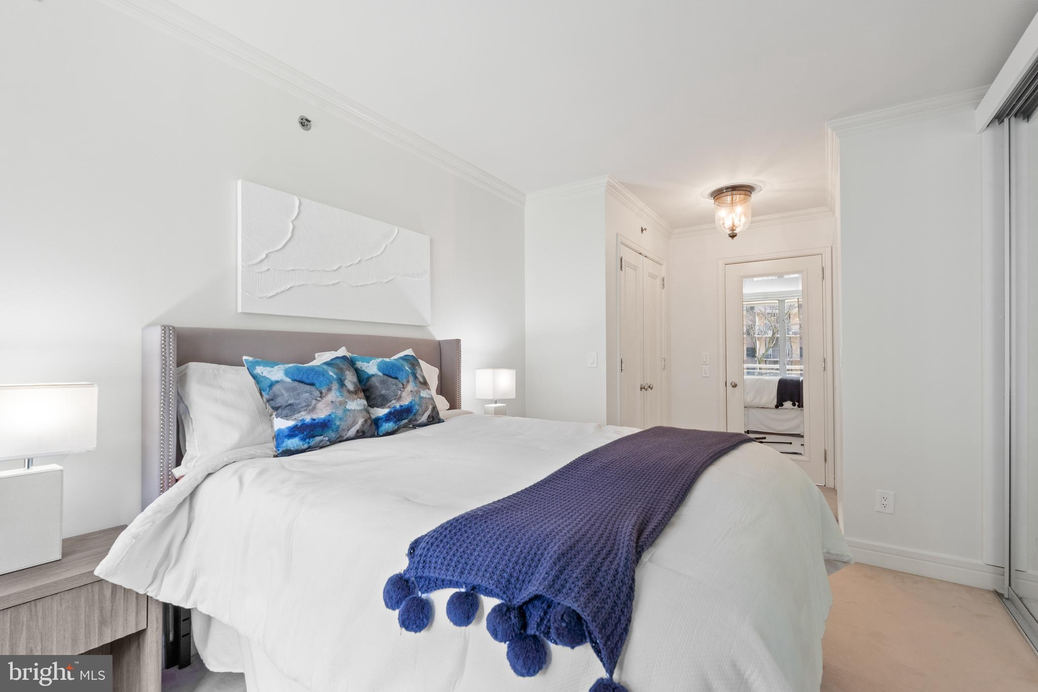 1111 23rd Street Northwest, Unit 4C Washington, DC 20037 - Photo 40 of 45 a bedroom with a bed and a lamp