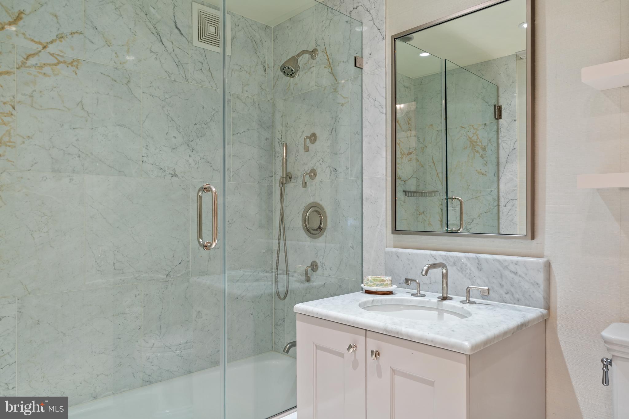 1111 23rd Street Northwest, Unit 4C Washington, DC 20037 - Photo 41 of 45 a bathroom with a shower sink and mirror