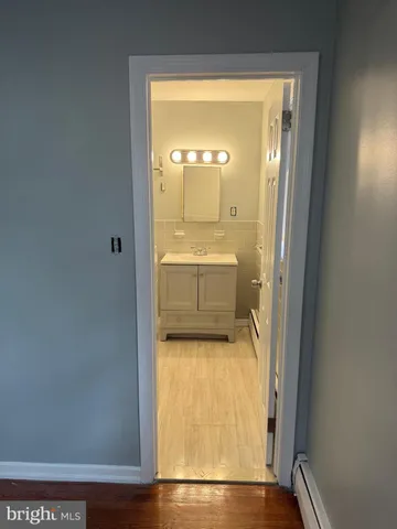 a view of a hallway with wooden floor