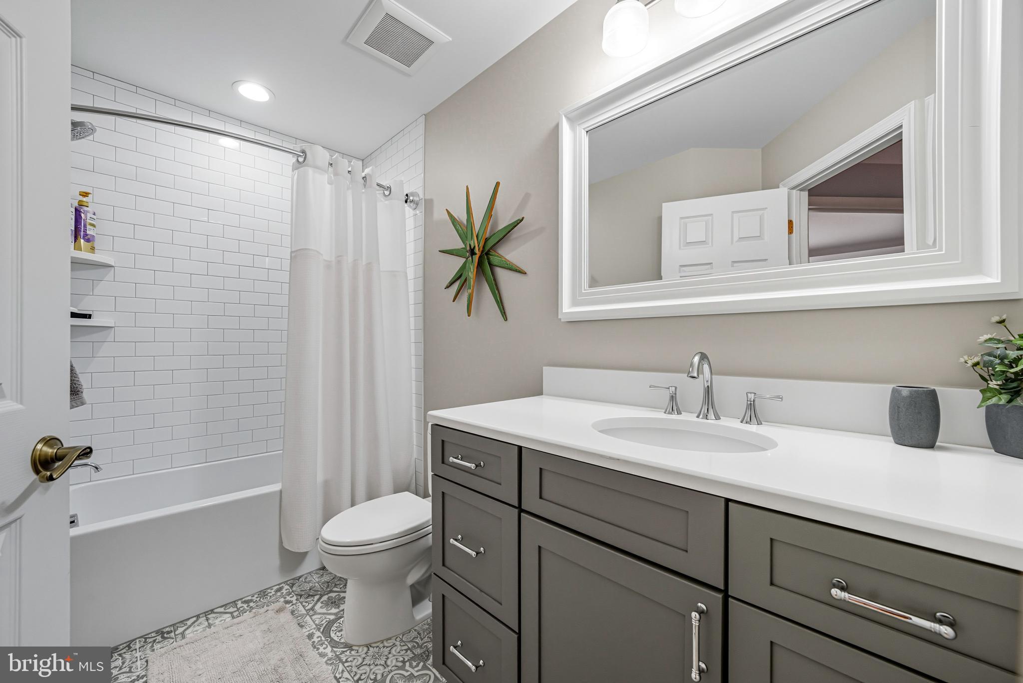 6 Edison Lane Doylestown, PA 18901 - Photo 13 of 24 a bathroom with a granite countertop sink toilet a large mirror a bathtub and shower