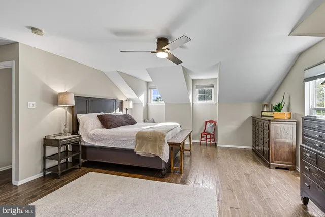 a bedroom with a bed a couch and a window