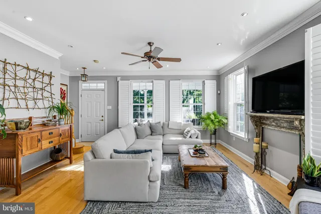 a living room with furniture a flat screen tv and a window