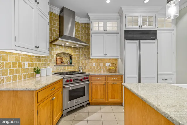 a kitchen with stainless steel appliances granite countertop a stove top oven a sink dishwasher and a refrigerator