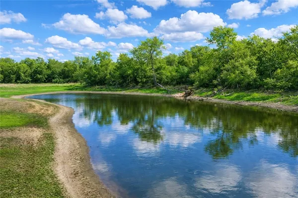 a view of a lake with a yard