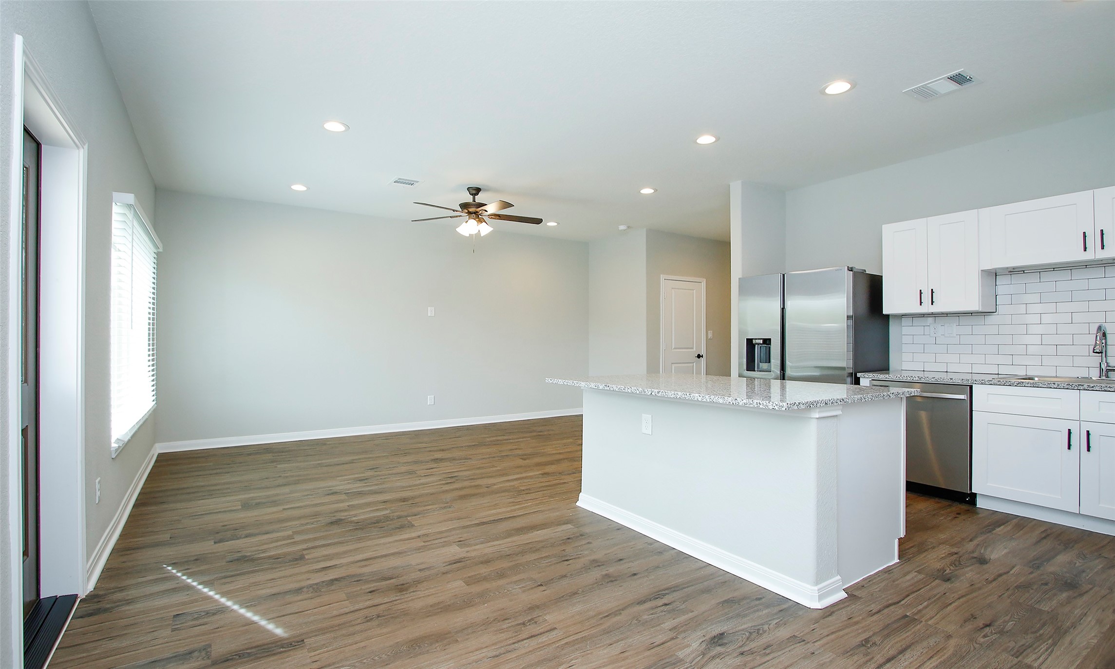 14010 Longstreet Road, Unit 1B Willis, TX 77318 - Photo 11 of 44 a large kitchen with stainless steel appliances a large counter top a sink and a refrigerator