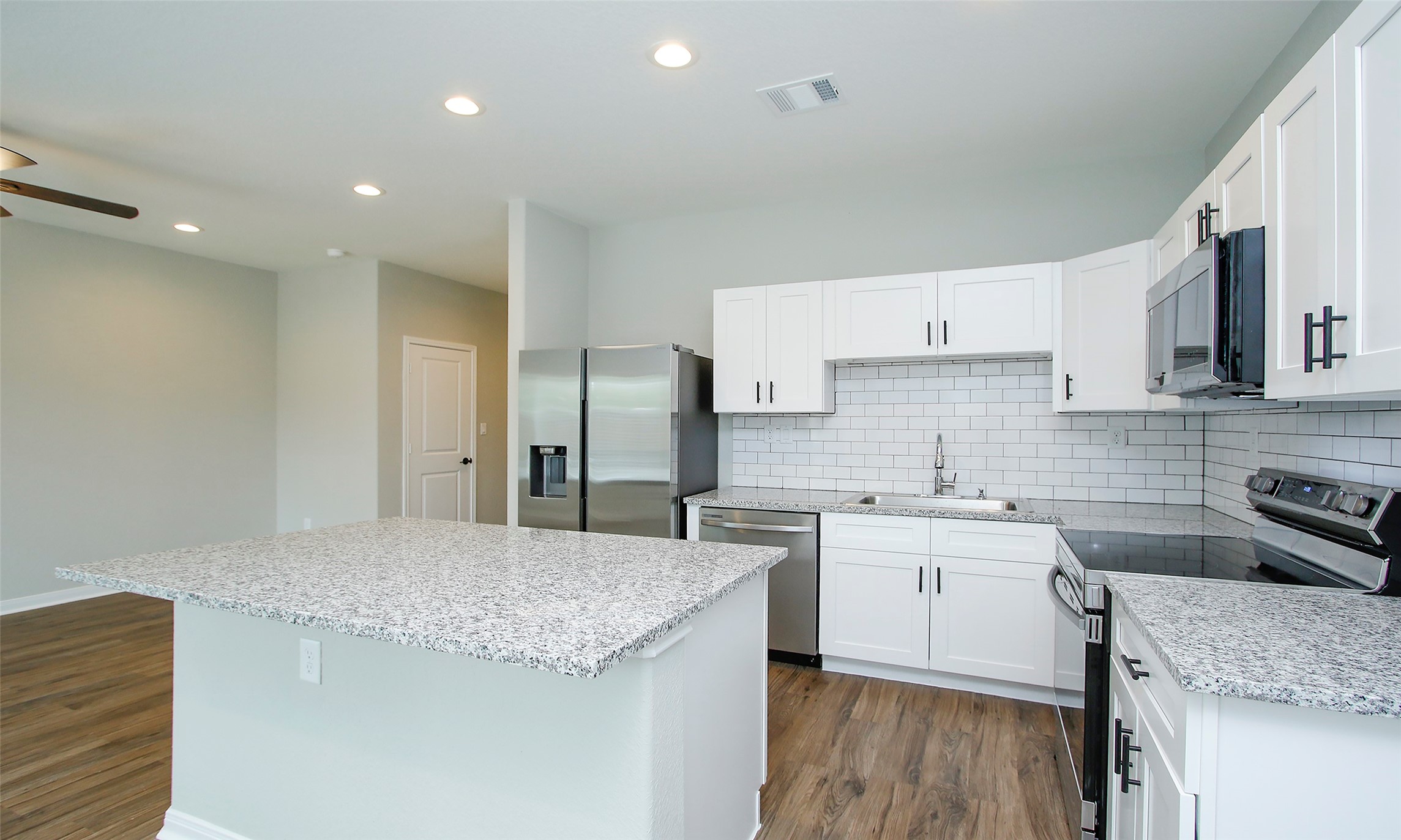 14010 Longstreet Road, Unit 1B Willis, TX 77318 - Photo 12 of 44 a kitchen with stainless steel appliances granite countertop a sink stove and refrigerator