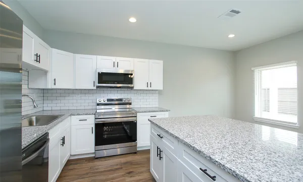 a kitchen with a stove and a microwave