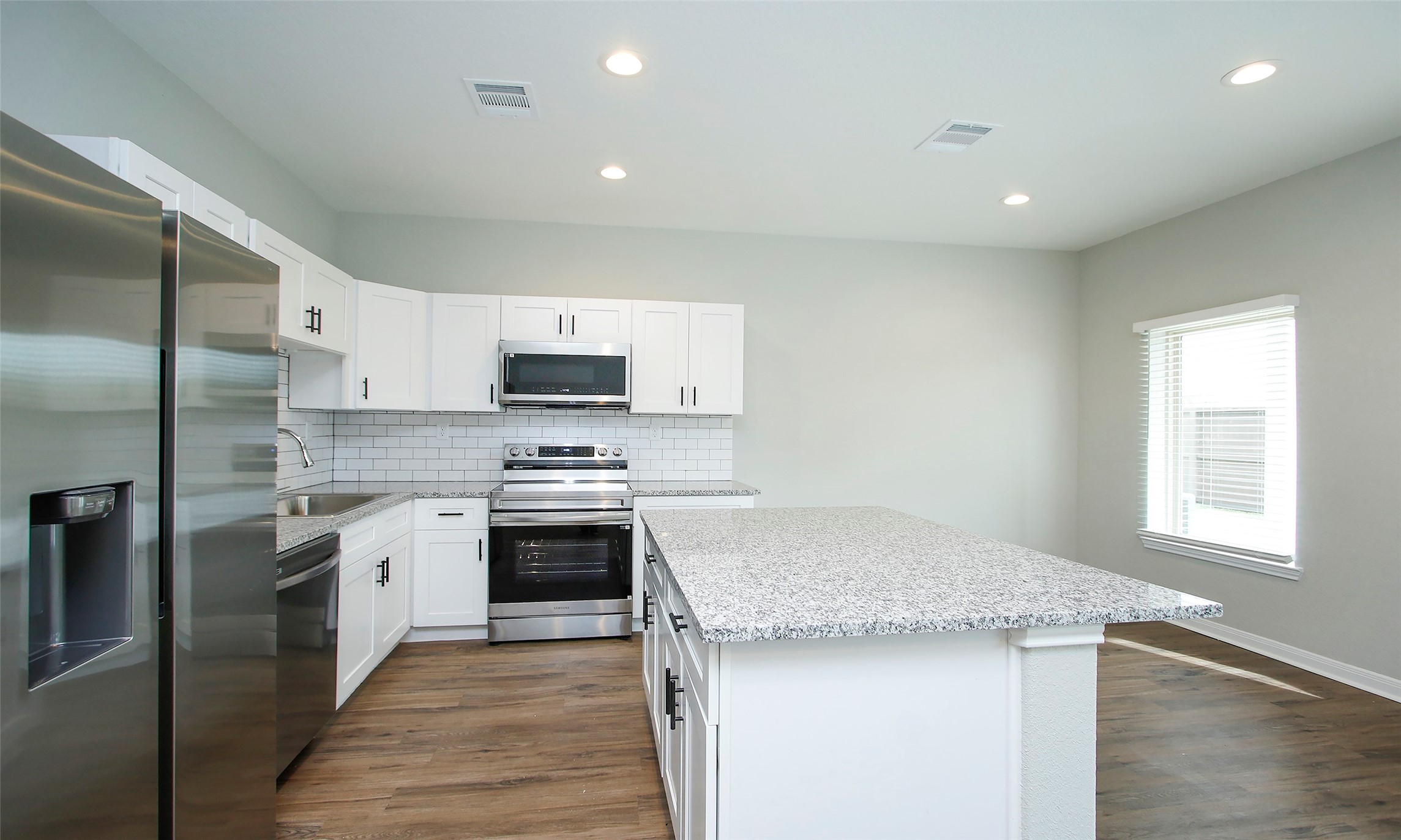 14010 Longstreet Road, Unit 1B Willis, TX 77318 - Photo 15 of 44 a kitchen with stainless steel appliances granite countertop a stove a sink and a refrigerator