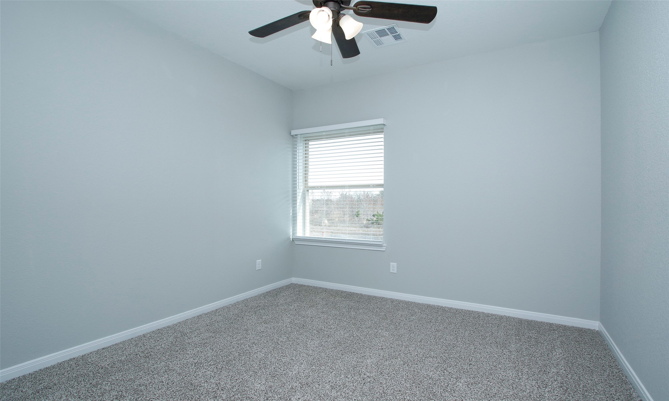 14010 Longstreet Road, Unit 1B Willis, TX 77318 - Photo 20 of 44 an empty room with a window and a fan