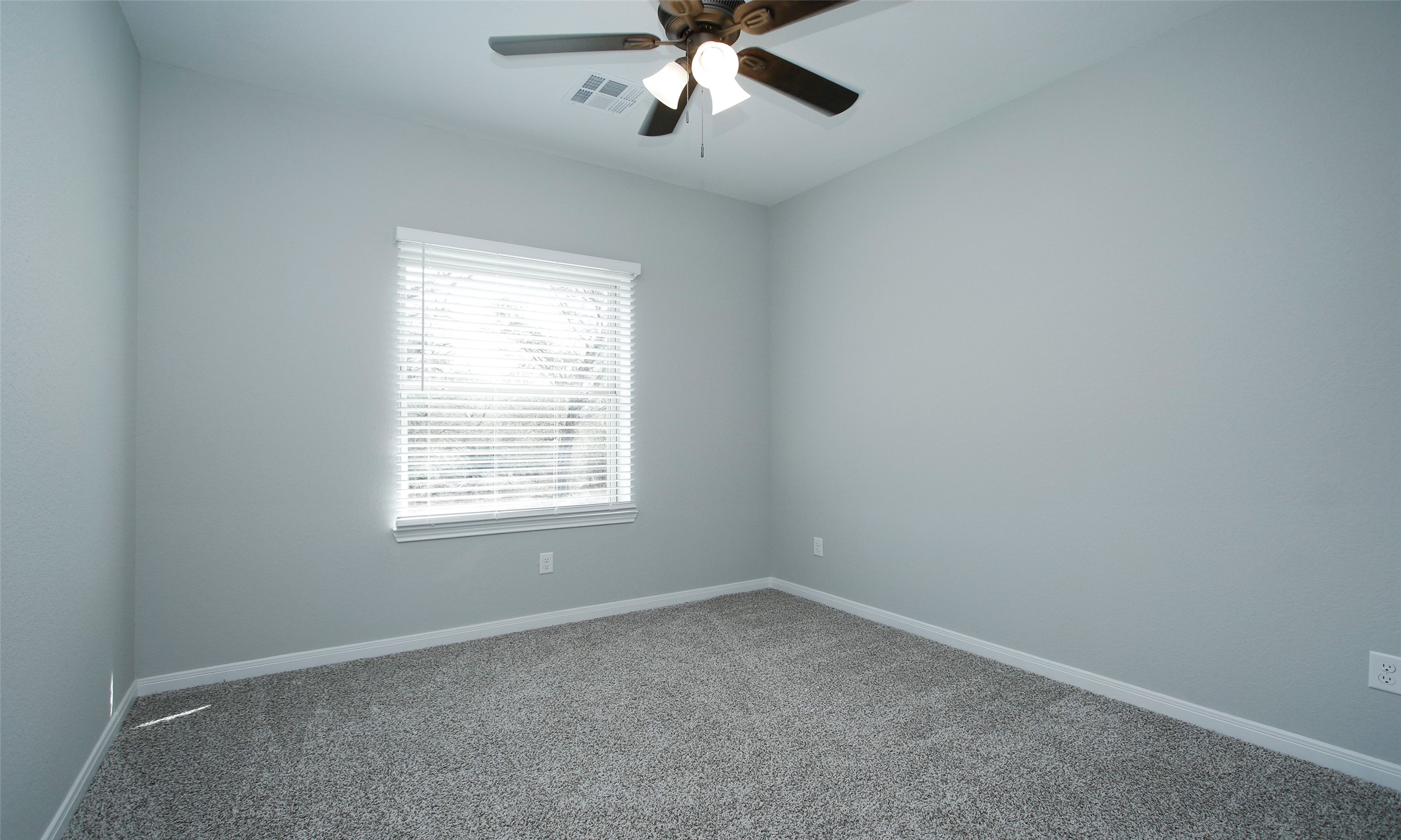 14010 Longstreet Road, Unit 1B Willis, TX 77318 - Photo 22 of 44 an empty room with a window and a fan