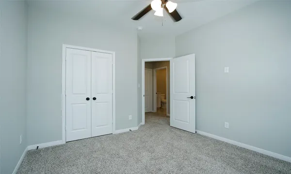 an empty room with a empty space and a ceiling fan