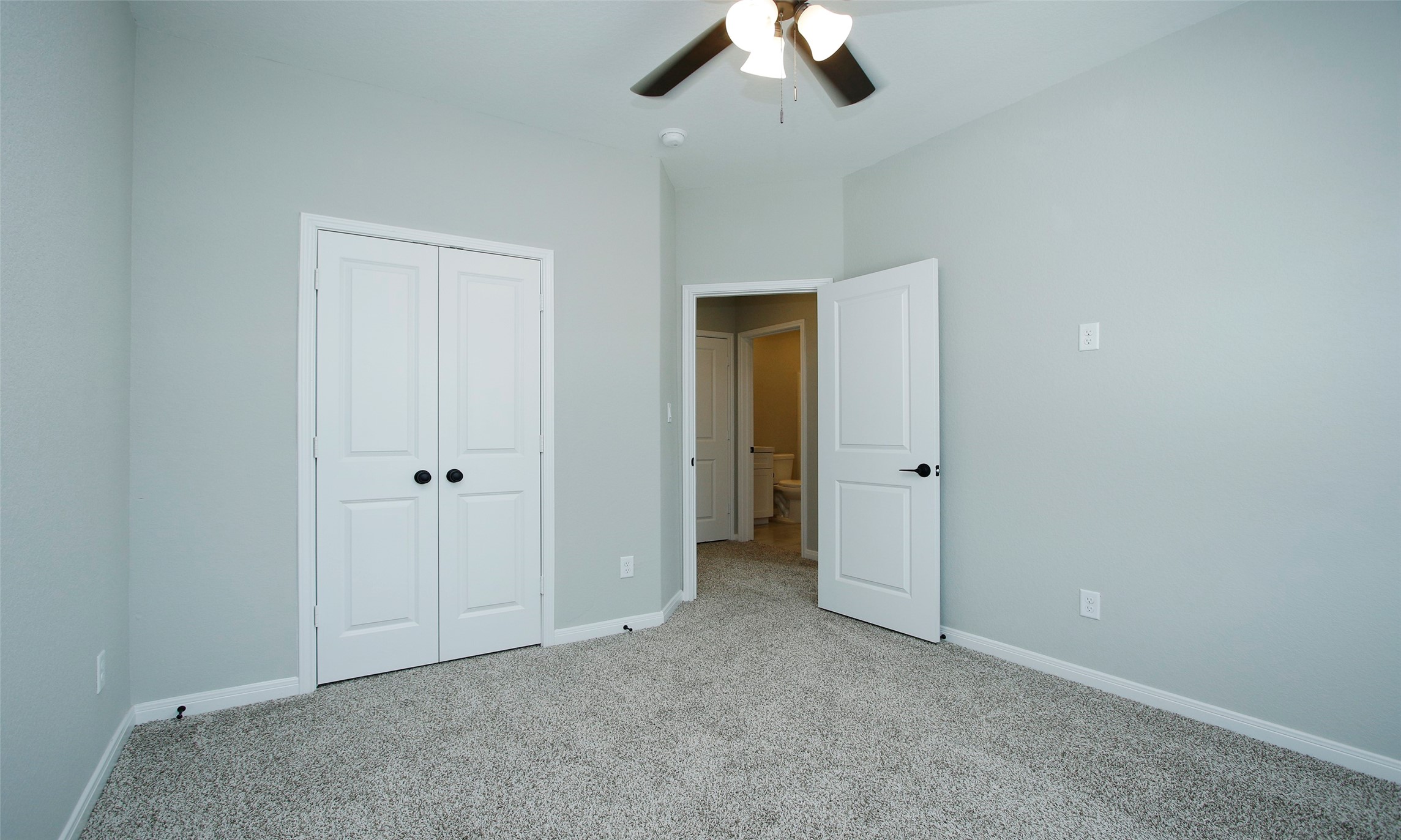 14010 Longstreet Road, Unit 1B Willis, TX 77318 - Photo 23 of 44 an empty room with a empty space and a ceiling fan
