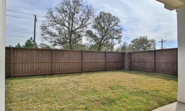 a view of yard with wooden fence