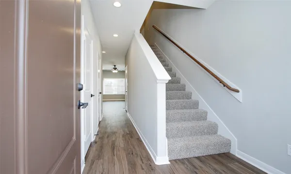a view of a hallway with wooden floor and entryway