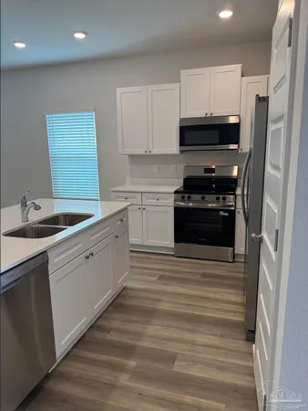 a kitchen with a sink stove and refrigerator