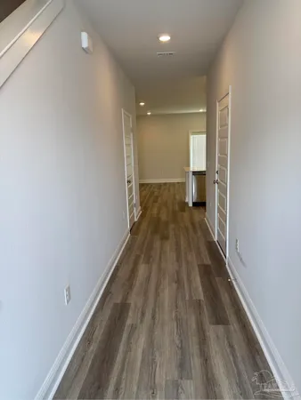 a view of a room with wooden floor
