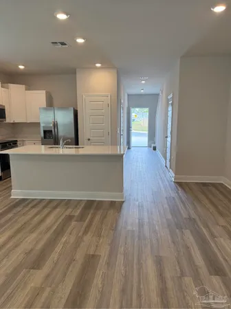 a view of kitchen with cabinets and wooden floor