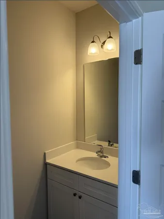 a bathroom with a sink and mirror
