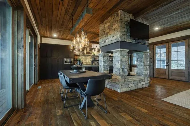 a living room with furniture a flat screen tv and a floor to ceiling window