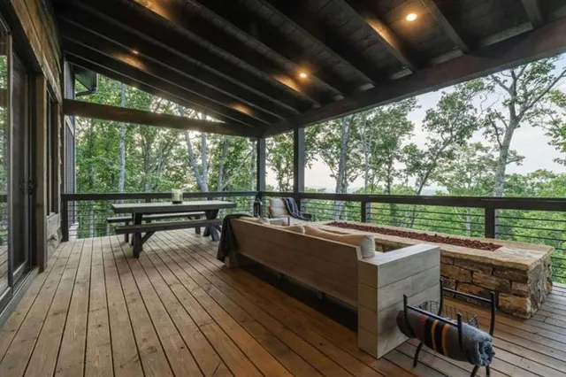a view of a livingroom with furniture wooden floor windows and a ceiling fan