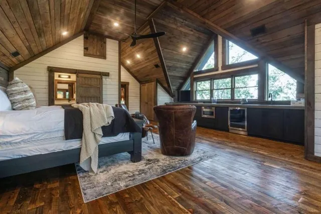 a view of a patio with a table and chairs and a barbeque