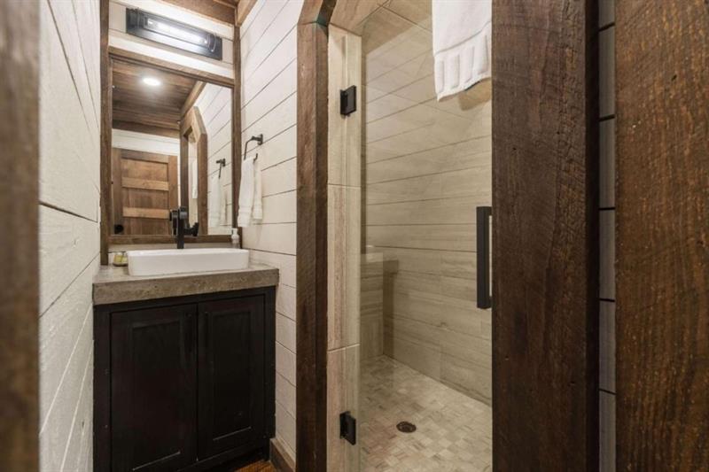 224 Eagles Ridge Morganton, GA 30560 - Photo 36 of 73 a bathroom with a shower sink and mirror