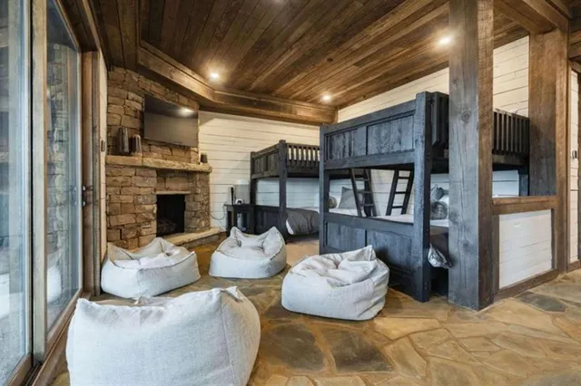 a view of a house with wooden deck and furniture