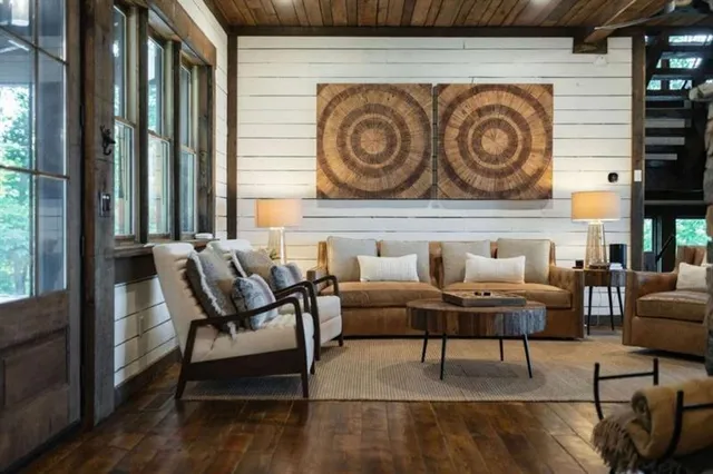 a living room with furniture and large windows