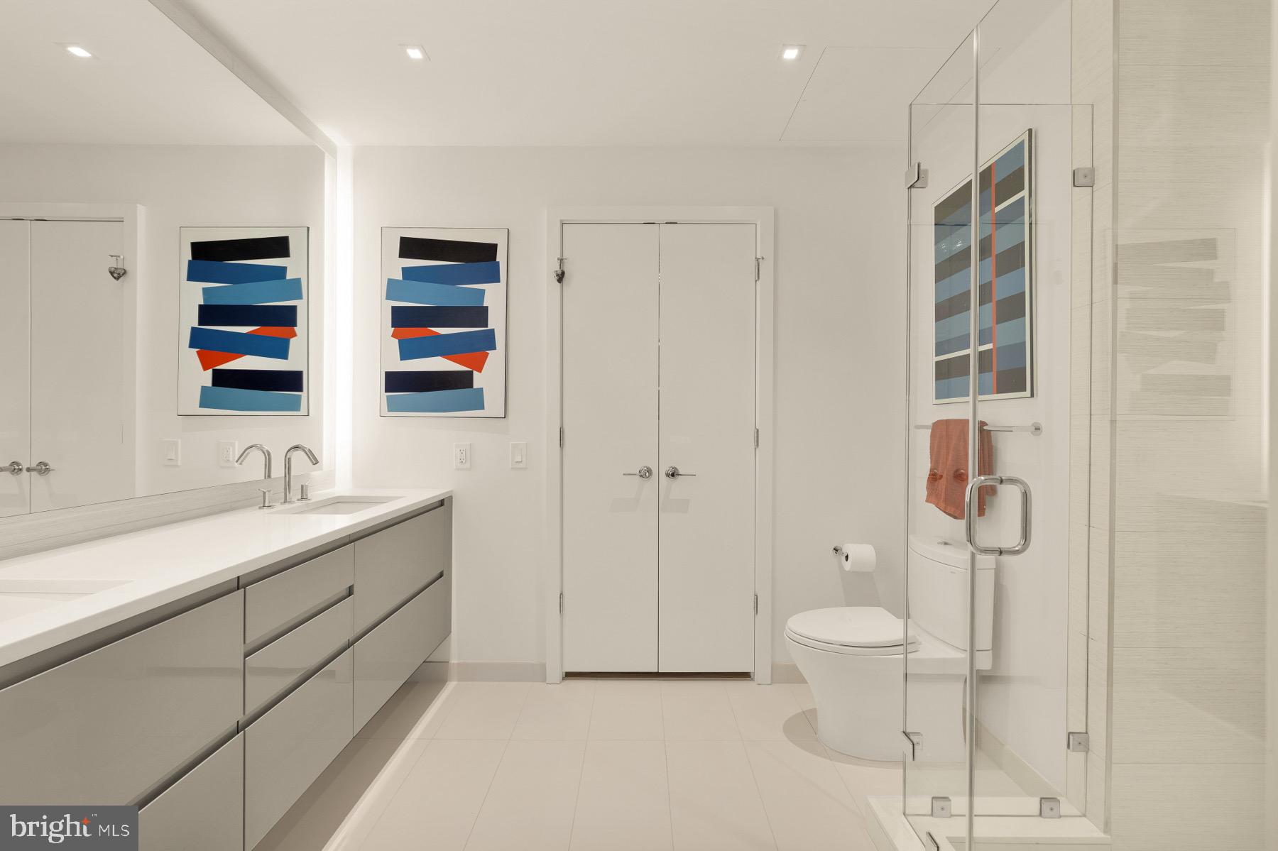 810 O Street Northwest, Unit 809 Washington, DC 20001 - Photo 14 of 30 a bathroom with a double vanity sink toilet and shower