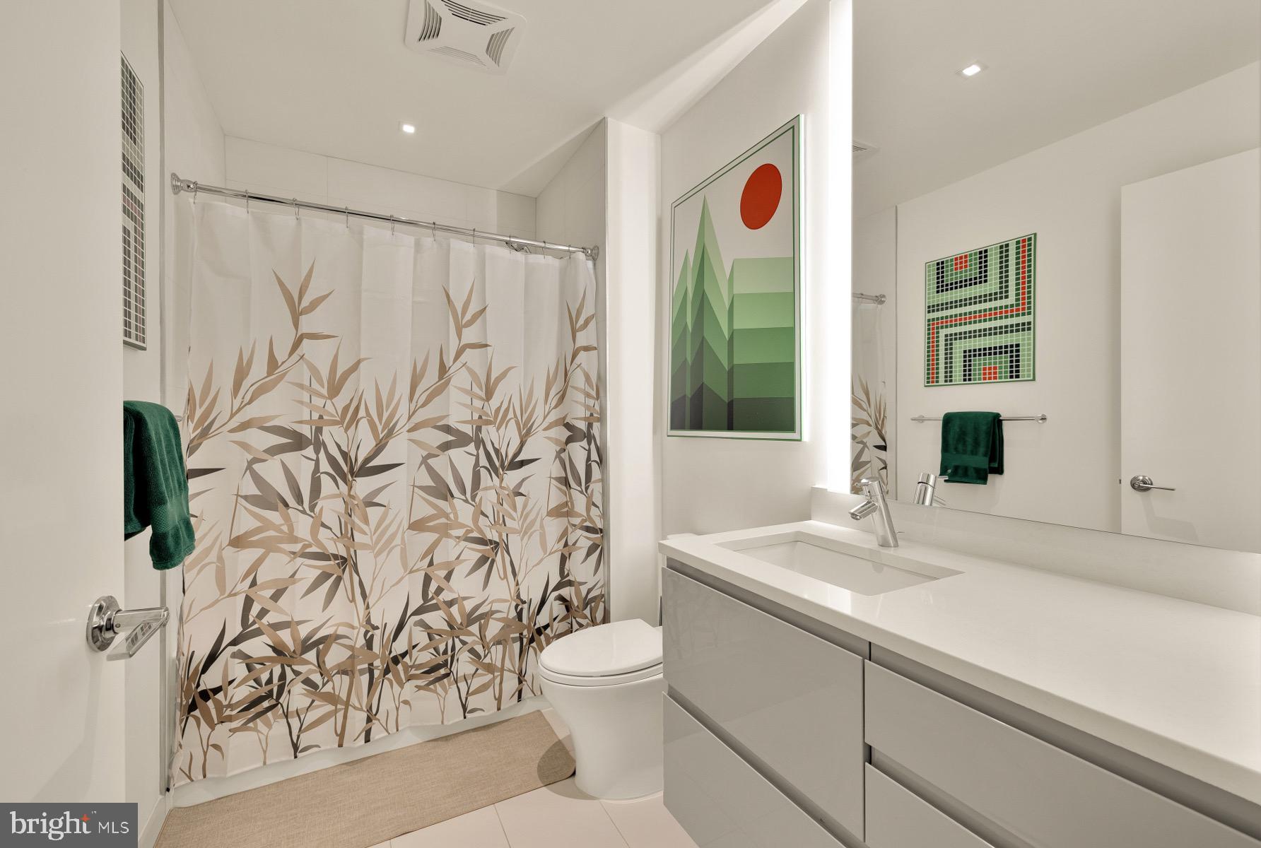 810 O Street Northwest, Unit 809 Washington, DC 20001 - Photo 19 of 30 a bathroom with a sink a toilet and a mirror