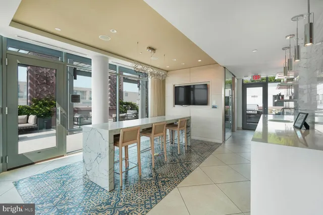 a view of a dining room kitchen with furniture and a flat screen tv