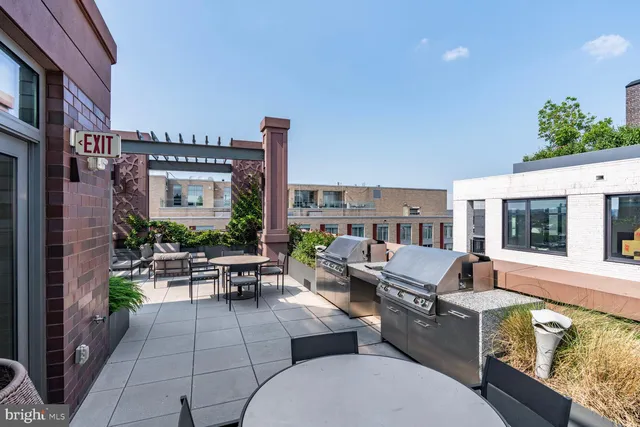 a outdoor space with patio the couches and a fireplace