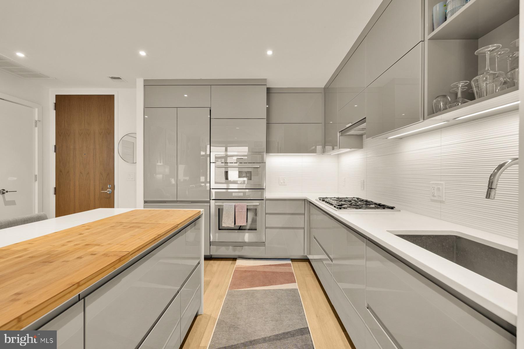 810 O Street Northwest, Unit 809 Washington, DC 20001 - Photo 5 of 30 a kitchen with a sink stove and cabinets