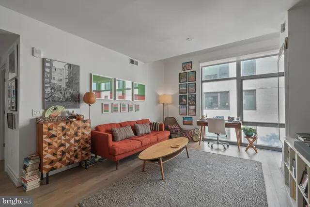 a living room with furniture and a large window