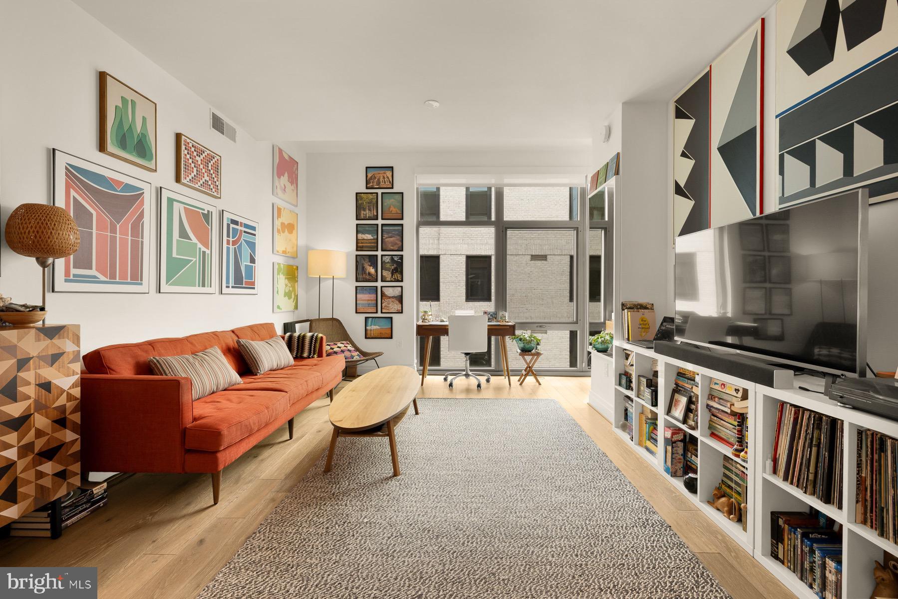 810 O Street Northwest, Unit 809 Washington, DC 20001 - Photo 8 of 30 a living room with furniture and a flat screen tv