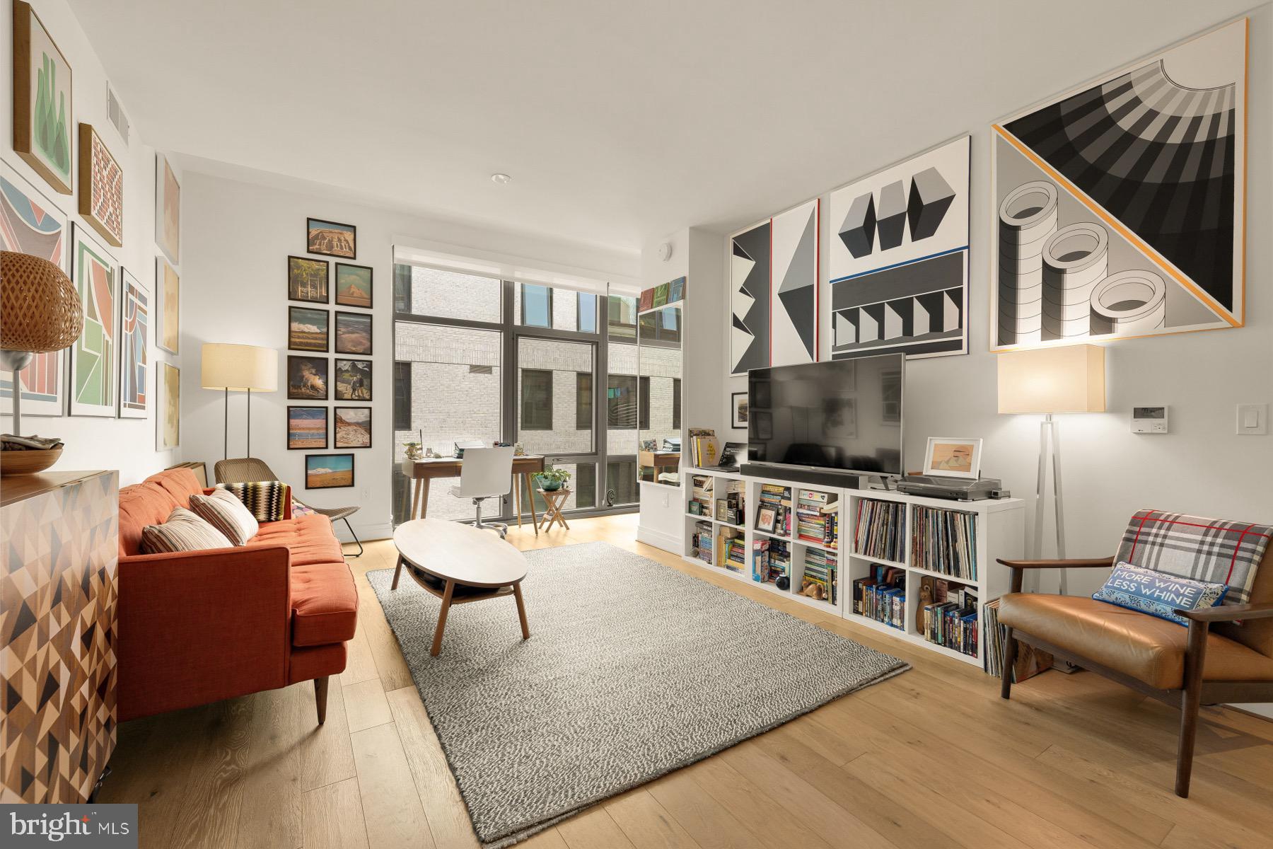 810 O Street Northwest, Unit 809 Washington, DC 20001 - Photo 9 of 30 a living room with furniture and a flat screen tv