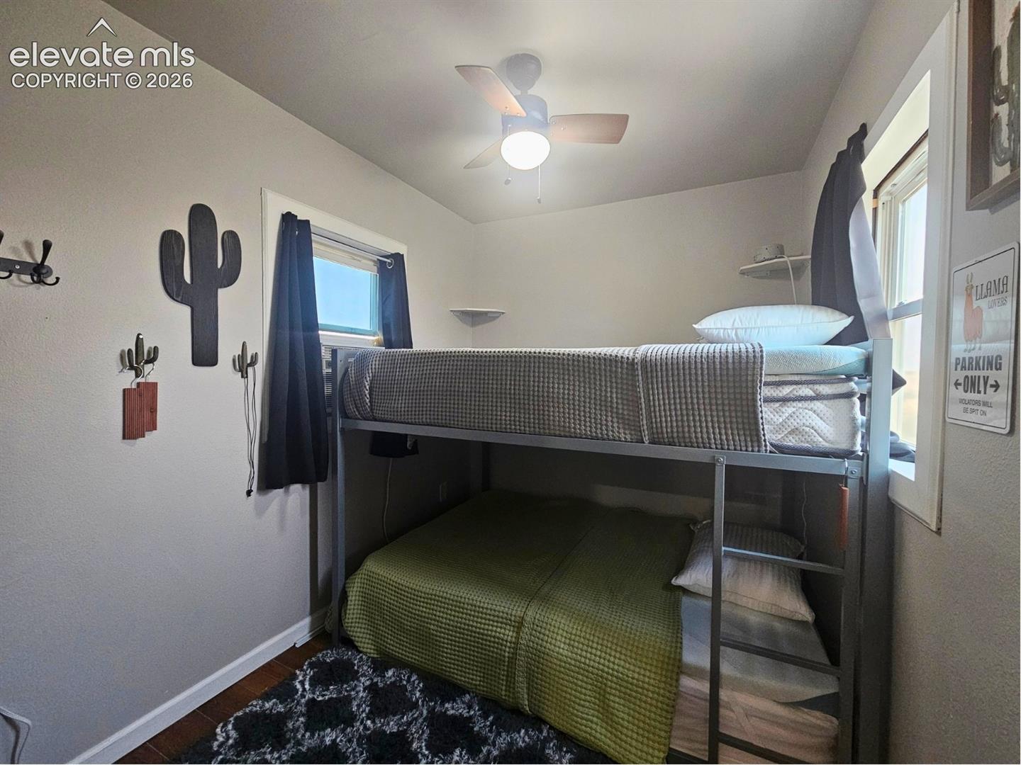 6650 Quail Road Fountain, CO 80817 - Photo 21 of 55 Compact sleeping area featuring a ceiling fan with light fixture, natural light from a window, and wood-finish flooring