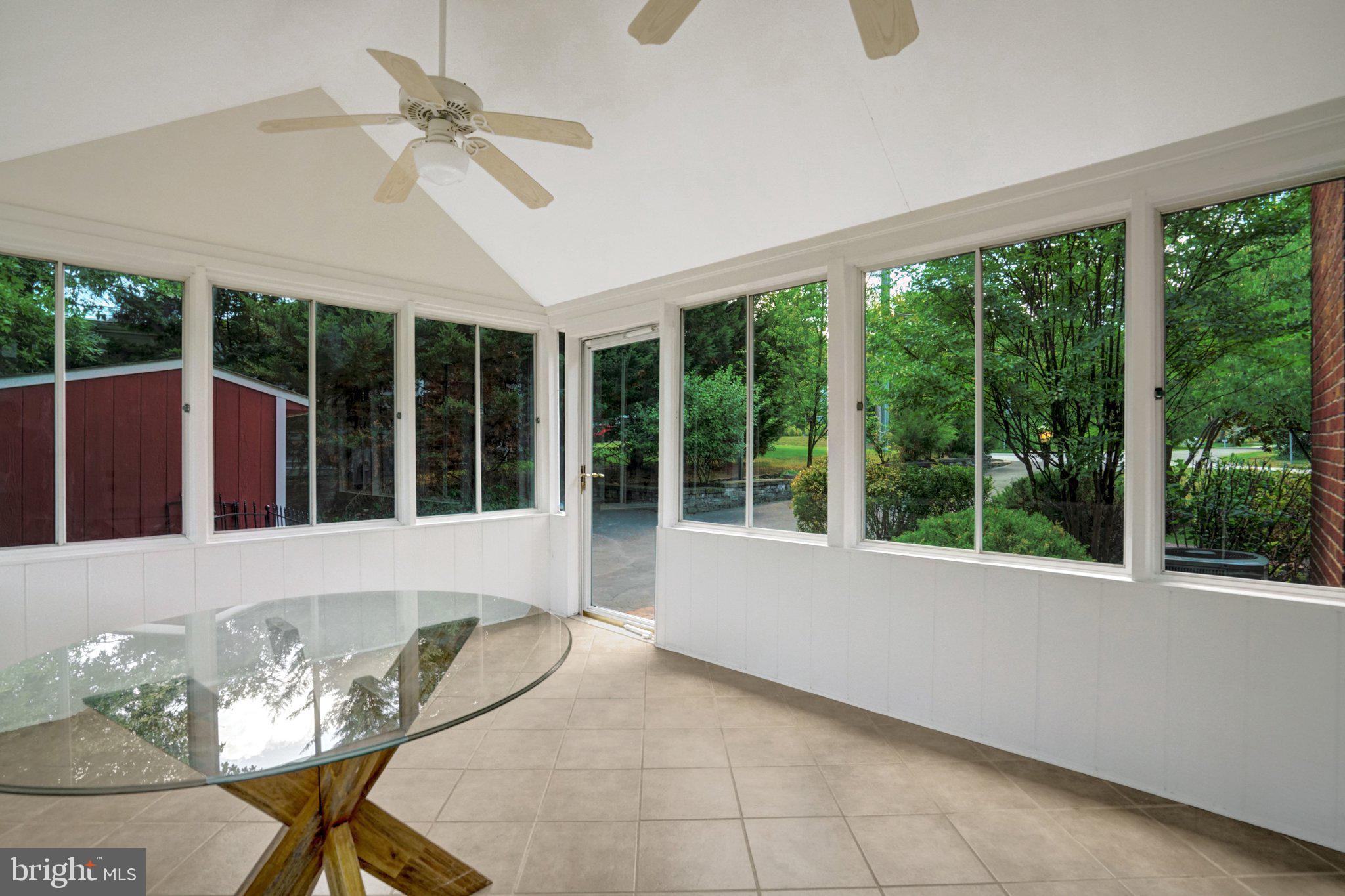 7107 Coventry Road Alexandria, VA 22306 - Photo 27 of 64 Bright sunroom with wooded views