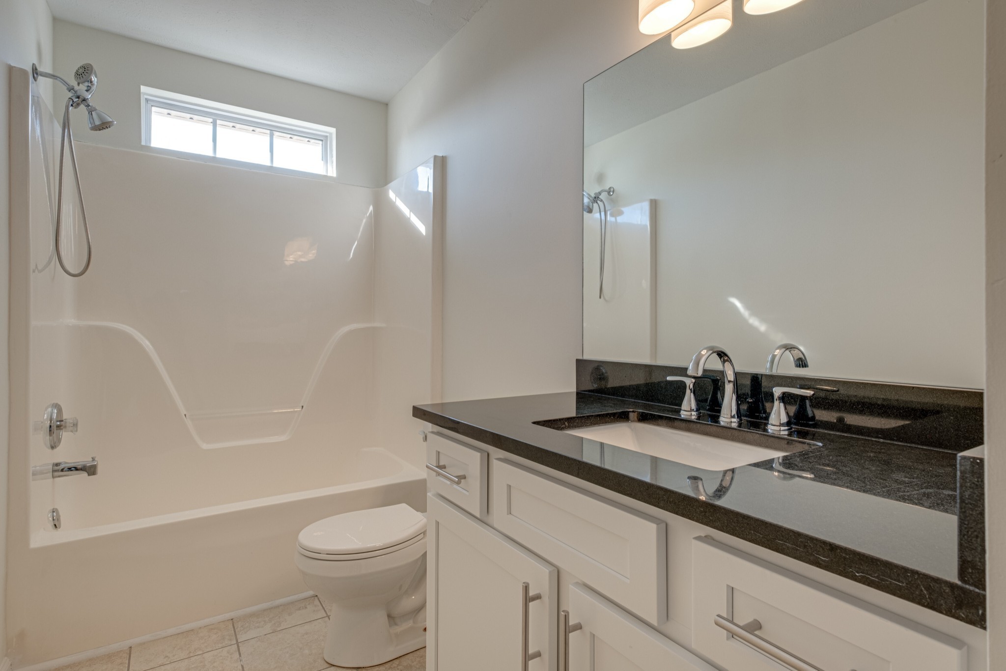 1029 Windtree Trace Mount Juliet, TN 37122 - Photo 15 of 18 a bathroom with a granite countertop sink a toilet a mirror and bathtub