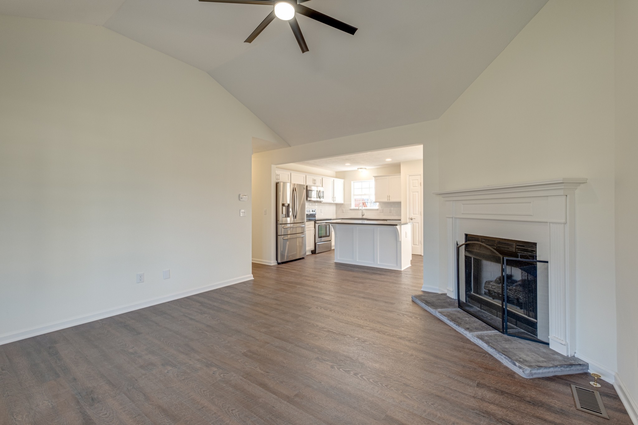 1029 Windtree Trace Mount Juliet, TN 37122 - Photo 2 of 18 an empty room with wooden floor fireplace and windows