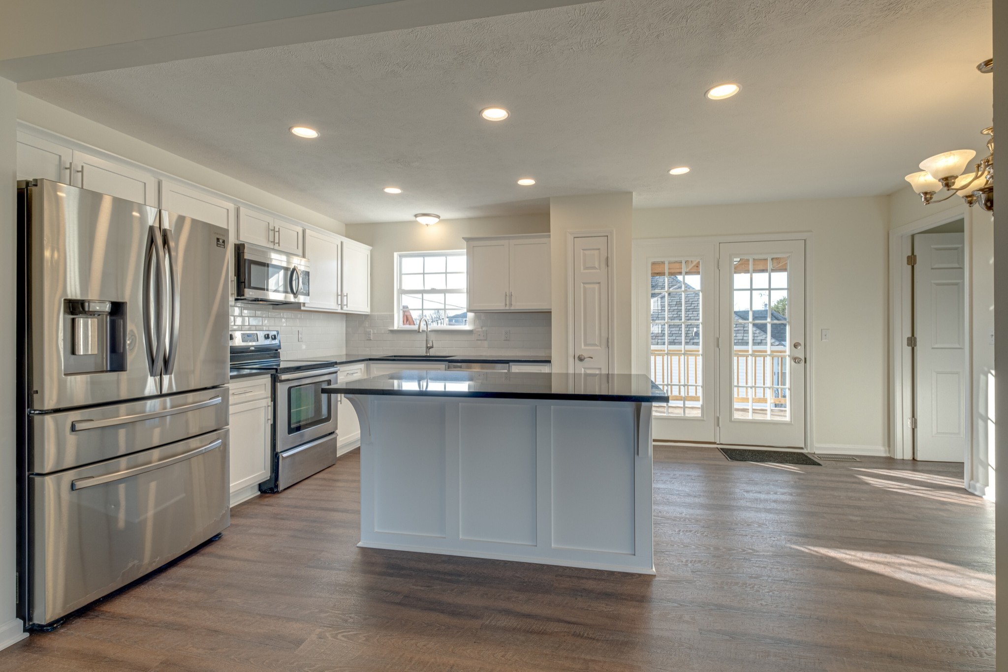 1029 Windtree Trace Mount Juliet, TN 37122 - Photo 3 of 18 a kitchen with stainless steel appliances granite countertop a refrigerator a sink dishwasher and a stove with wooden floor