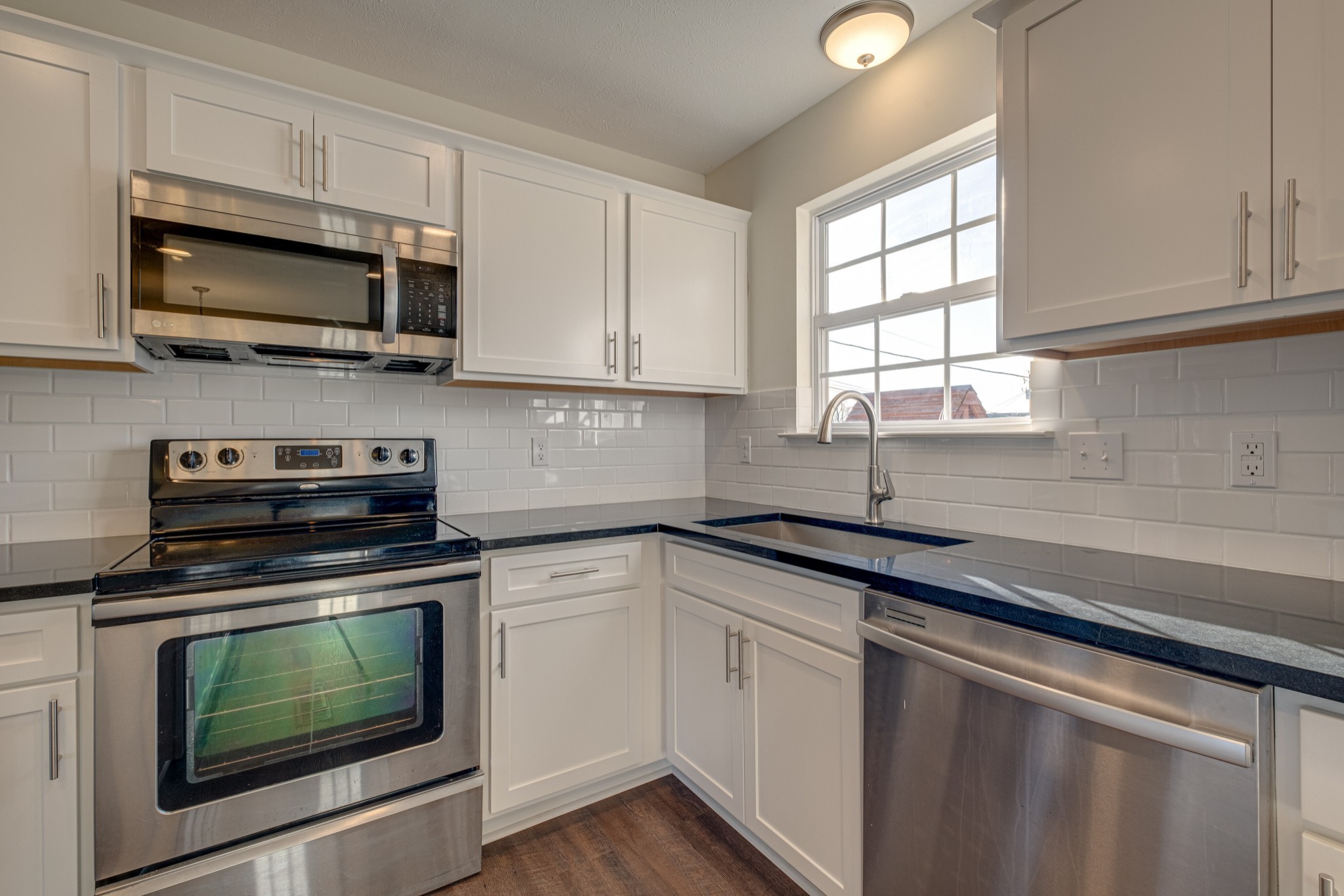 1029 Windtree Trace Mount Juliet, TN 37122 - Photo 4 of 18 a kitchen with stainless steel appliances granite countertop white cabinets granite counter tops and a window