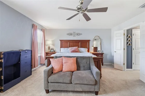 a bedroom with furniture and a ceiling fan
