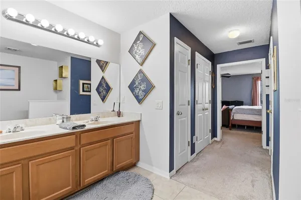 a en suite bathroom with a double vanity sink and a mirror