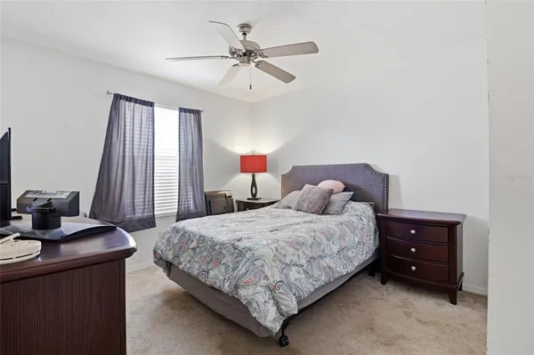 a bedroom with a bed and a desk