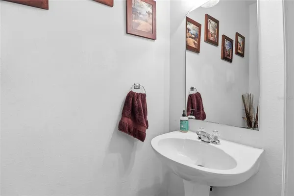 a view of a storage & utility room with fridge
